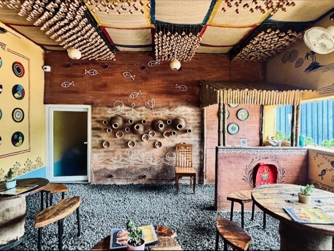 Inside Chinsurah: mud walls set with clay pots, terracotta strings across the ceiling, low wooden tables